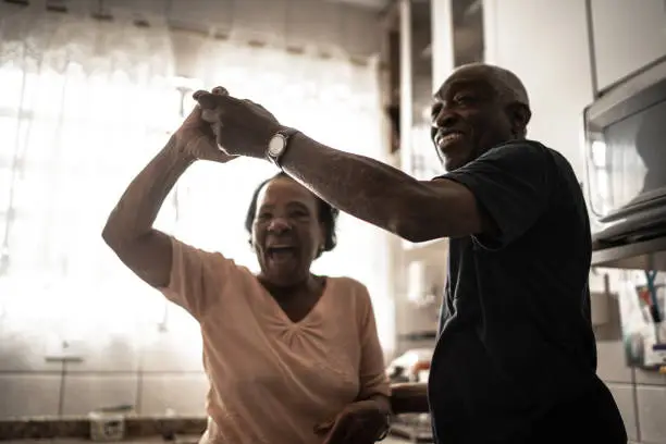 Senior couple dancing at kitchen