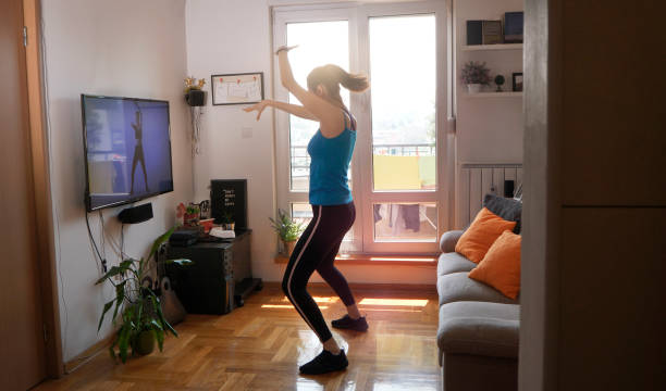 istock Woman exercising and watching online workout video 1219559965