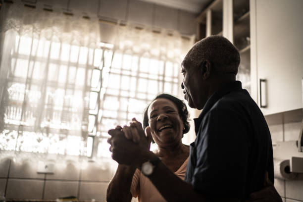 istock Senior couple dancing at kitchen 1219560019