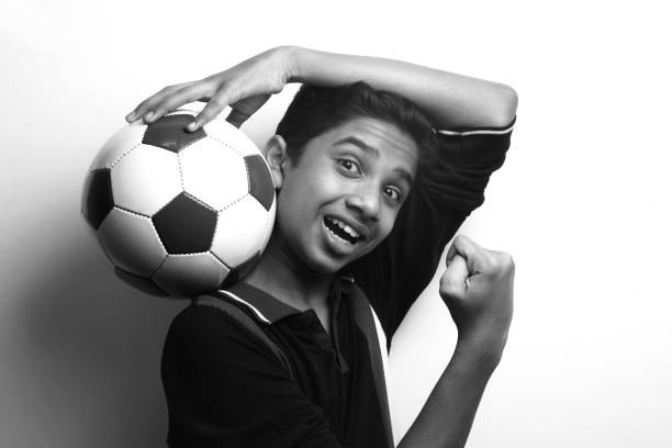 istock Energetic young boy holding a soccer ball 1219560947