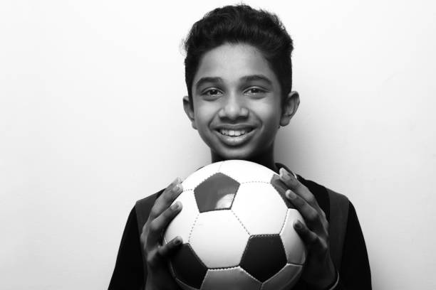 istock Energetic young boy holding a soccer ball 1219560948