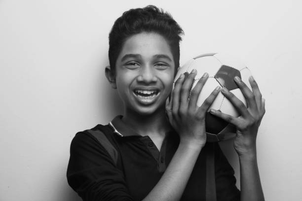 istock Energetic young boy holding a soccer ball 1219560951