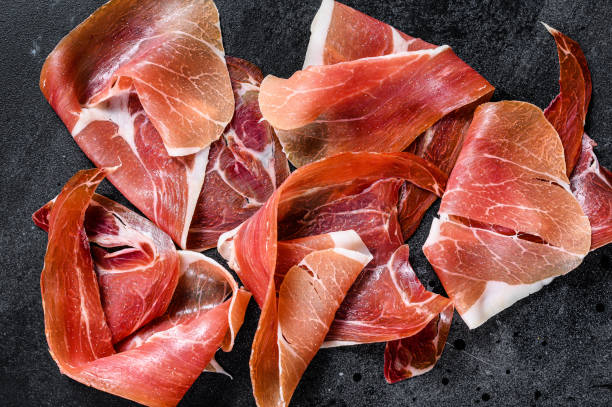 istock Spanish jamon Serrano, ham. Black background, top view 1219561408