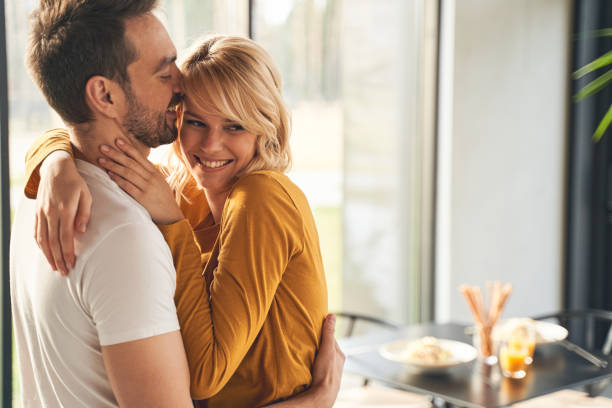 istock Smiling man holding his wife in arms 1219561507