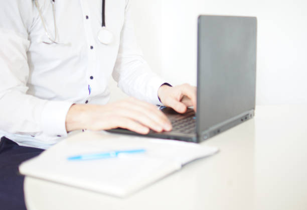 istock Working with laptop computer in the medical workplace office focus. 1219562216