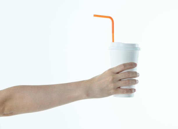 istock Woman hand holding a white disposable cup 1219562266