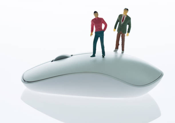 istock Two people figurine standing on computer mouse 1219562316