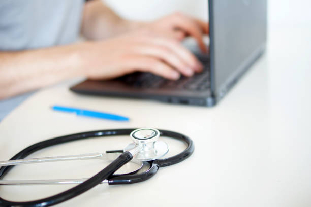 istock Working with laptop computer in the medical workplace office focus. 1219562323