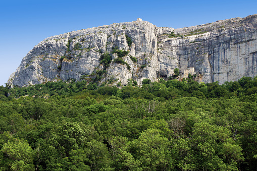 Sanctuary  installed in a cave at the foot of the cliff, above the national forest.