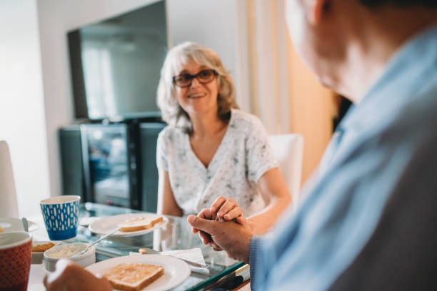 istock Mature couple holding hands and doing breakfast together 1219562607