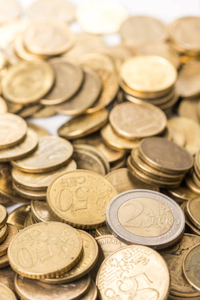 Pile of metal euro coins with backlight stock photo