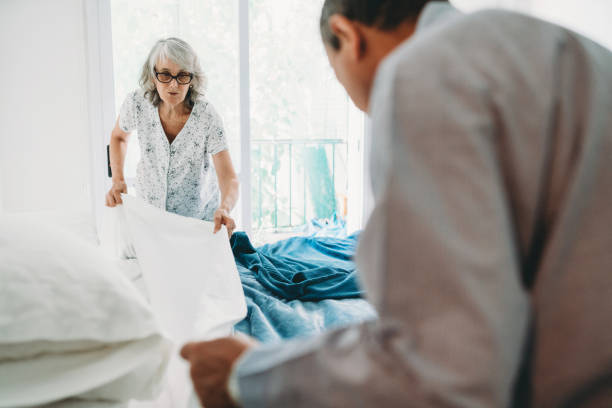 istock Mature couple making the bed together 1219562620