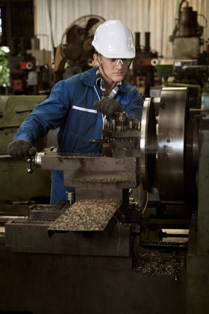 istock A male factory worker is working on a metal milling machine. 1219563089