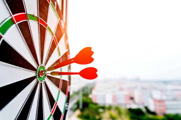istock Dart board with three darts outdoors 1219564370