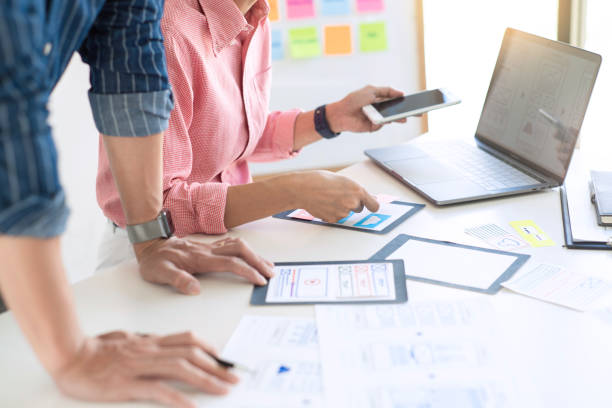 istock Graphic designers team work together with UX UI designer planning application template layout mobile phone prototype, User experience concept. 1219565763