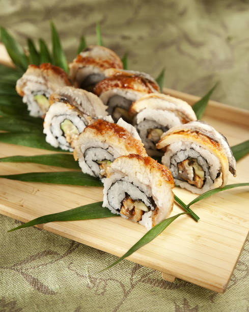 istock Sushi rolls on a wooden board 1219568553