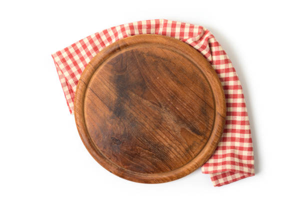 istock Round pizza board with red checked tablecloth on white background. Cooking or baking mock up for design. Top view from above 1219568613