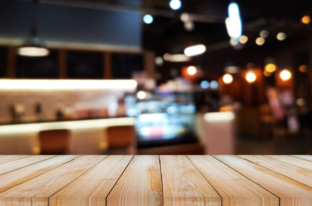 istock wooden table with abstract blurred background resturant lights used for display montage products mock up design. 1219569409
