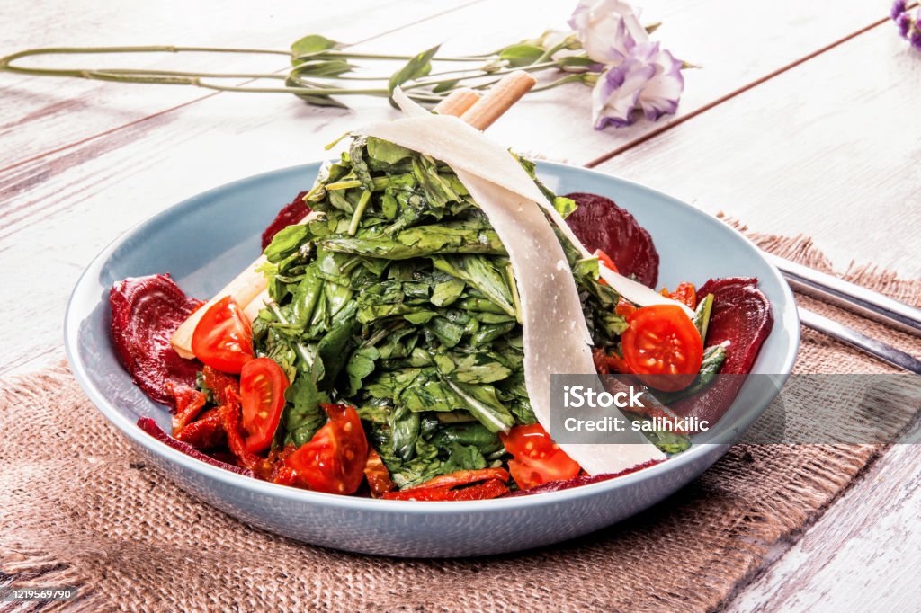 Arugula Salad with Beets and Tomatoes Arugula salad with beets, tomato and cheese Antioxidant Stock Photo