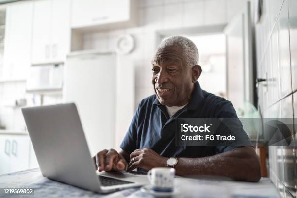 Senior Man Working At Laptop At Home Stock Photo - Download Image Now - Senior Adult, Using Computer, Computer