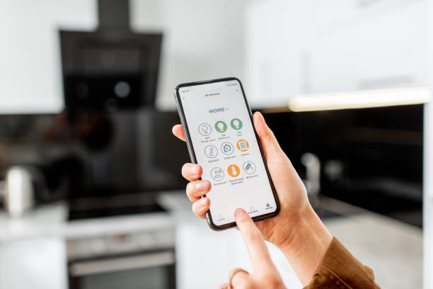 istock Controlling kitchen appliances with a smart phone 1219569830