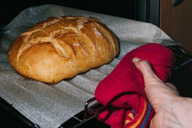 istock taking the bread out of the oven freshly made 1219573825