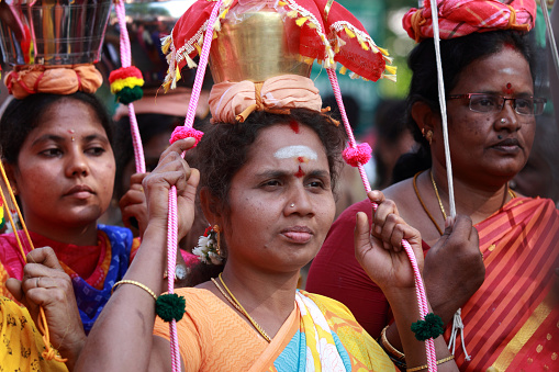 Palani,India - February 08,2017: Hindu women devotees carry scared pots on their heads and participates in the Thaipusam festival at the Murugan temple in Palani,Tamil Nadu, India