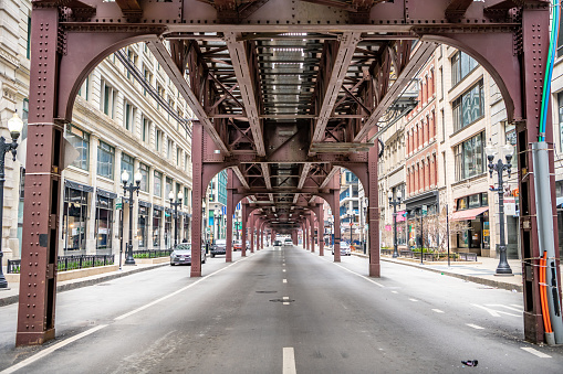 Chicago, IL / USA - April 11,2020: View of an empty street under the train tracks in the Loop. Streets in the Loop are empty during the city's lockdown for Covid-19.