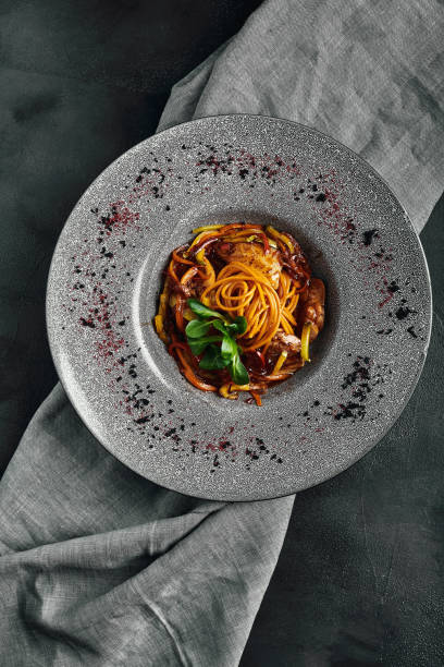 spaghetti with vegetables tomato sauce and meat. traditional italian food. food photo. dish from the chef. beautiful feed, close-up shot, top view, copy space - clothing traditional culture chinese culture black imagens e fotografias de stock