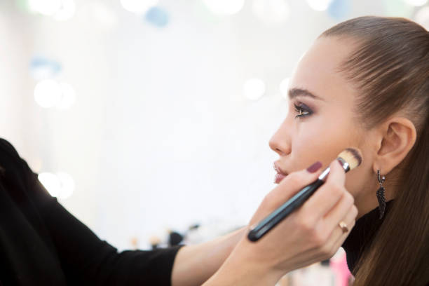 istock Professional make up artist doing make up in beauty salon 1219576411