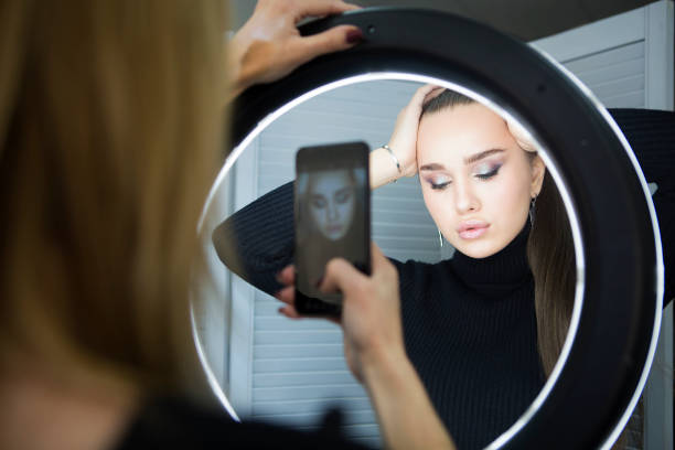 istock Make up artist taking mobile photo for the model 1219577324