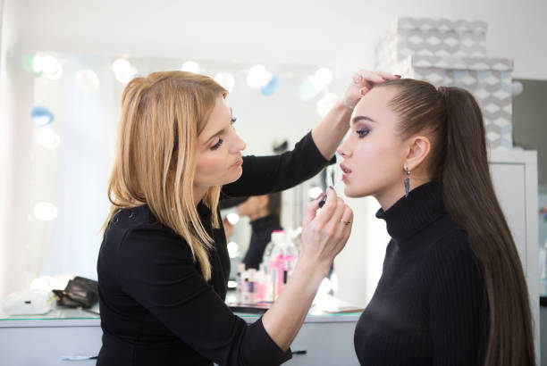 istock Professional make up artist doing make up in beauty salon 1219577751
