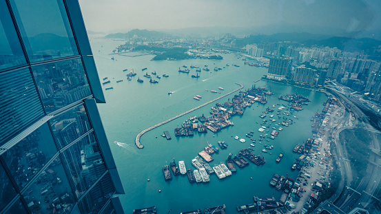 Boats moored in Hong Kong harbor, West Kowloon. Kowloon peninsula.