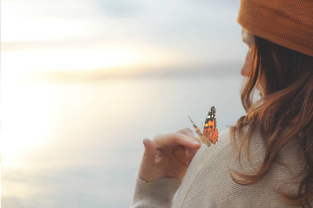 istock delicate moment  between a butterfly and a woman 1219580199