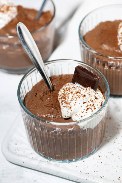 istock sweet chocolate mousse with whipped cream, closeup 1219580477