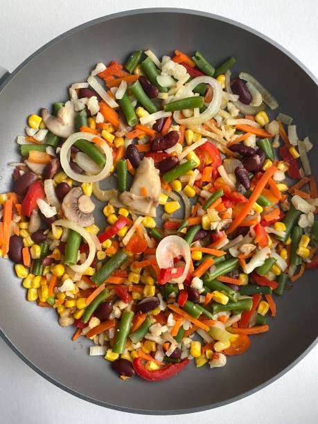 istock vegetables in a pan top view. Onions and champions 1219581610