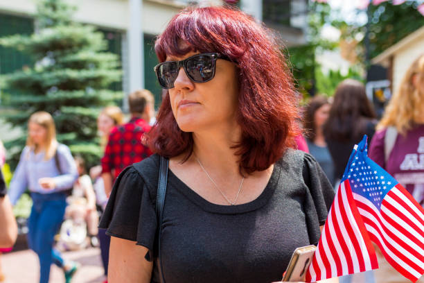 istock Woman with american flags in hands 1219581746