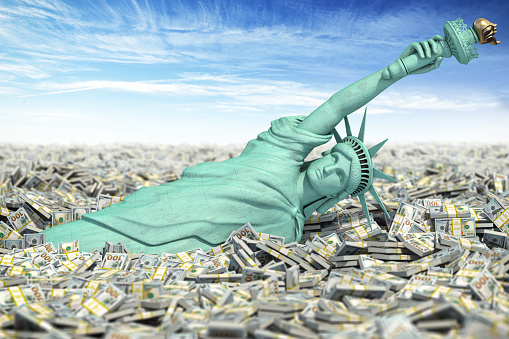 Crisis e inflación en Estados Unidos, no hay límite para las inyecciones de dinero de la Fed. Estatua de Libety cae a un montón de paquetes de dólares. photo
