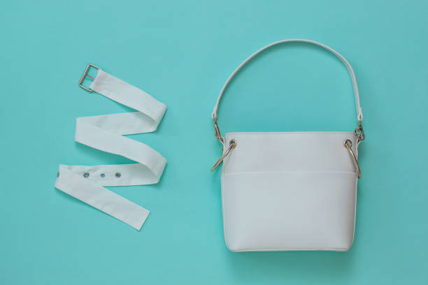 istock White women's bag and white fabric belt on a light background. Flat lay. 1219583189