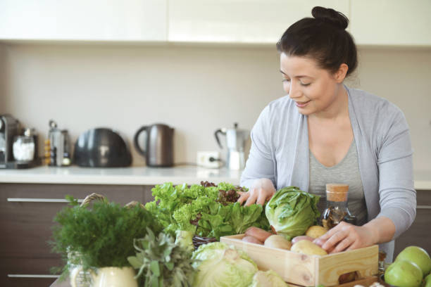 istock woman in the kitchen preparing food 1219583822