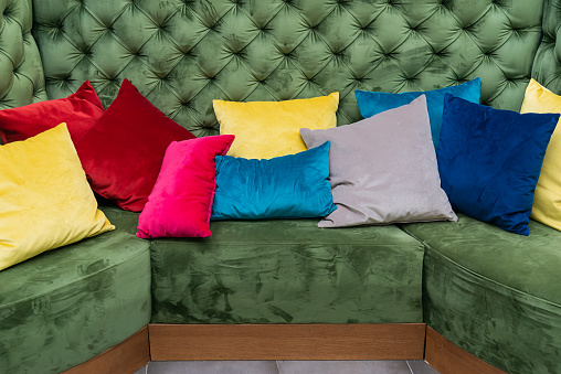 Real photo of colorful pillows on a sofa. Detail image of colorful cushion on sofa, living room, modern house, home decoration