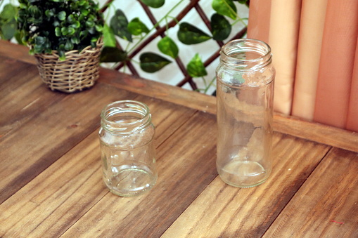 Two empty glass jars of different sizes