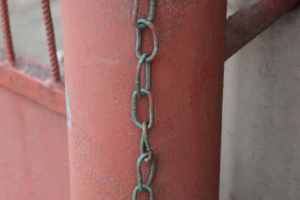 istock old iron chain hanging on a red metal pipe 1219588191