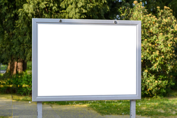 istock Blank ad space on a sign in a park on sunny day 1219589573
