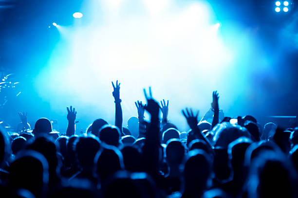 istock A blue spotlight shinning on a concert crowd 121959121