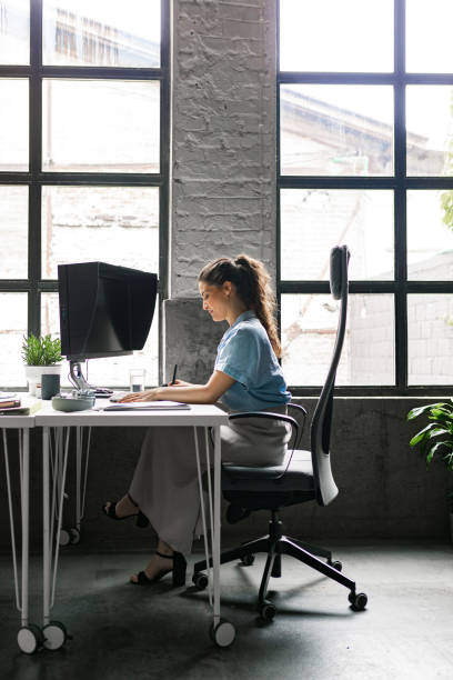 istock Beautiful Businesswoman Working at a Modern Open Space Loft Office 1219591601