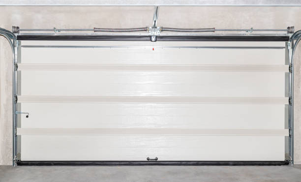 istock Closed white garage door with electric drive, view from the inside. 1219591645