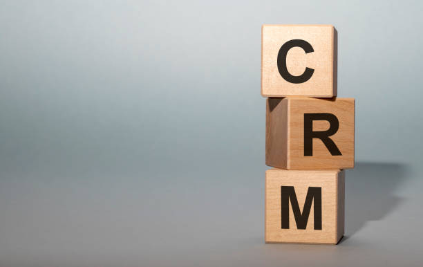 istock CRM, Customer Relationship Management on wooden cubes on grey blue background. 1219592504
