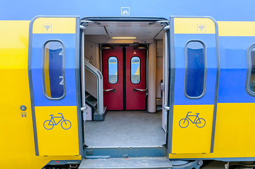 Yellow and blue train at a platform in Europe