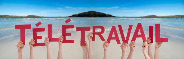 istock People Hands Holding Word Telework Means Home Office, Ocean Background 1219594192